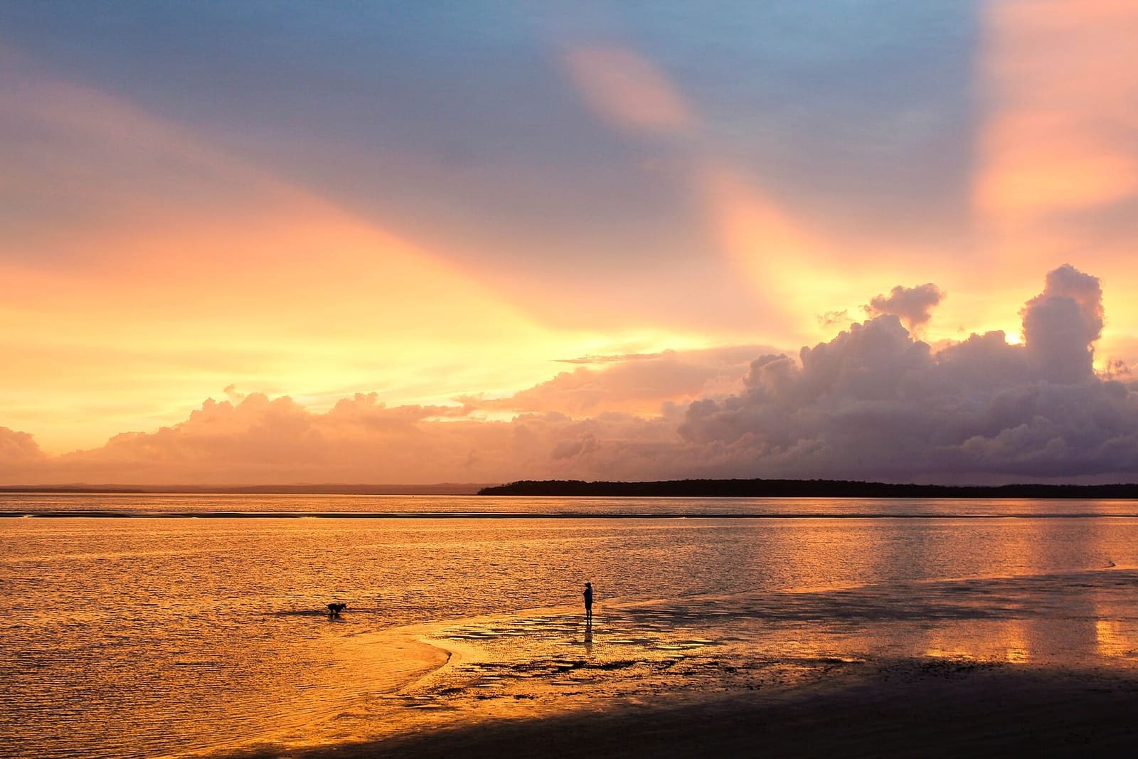 Sunset over the Great Sandy Strait from Urangan, with a figure out on the tidal flats