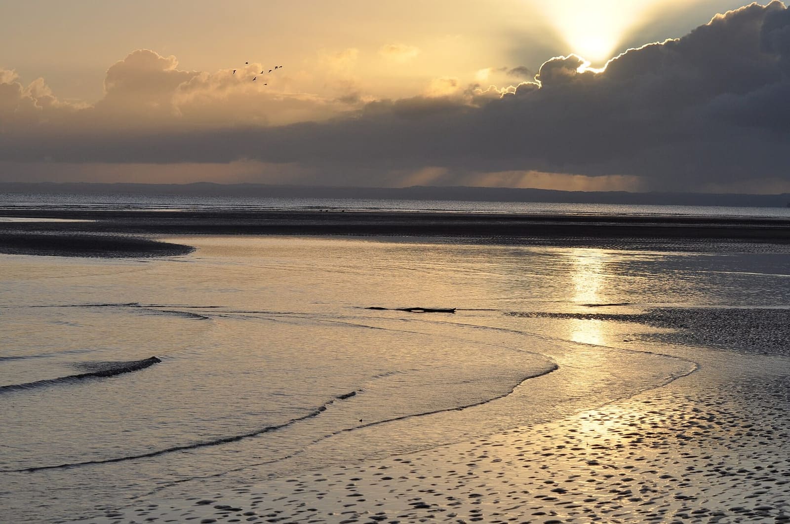 Hervey Bay beach at sunrise with low-tide ripples in the sand