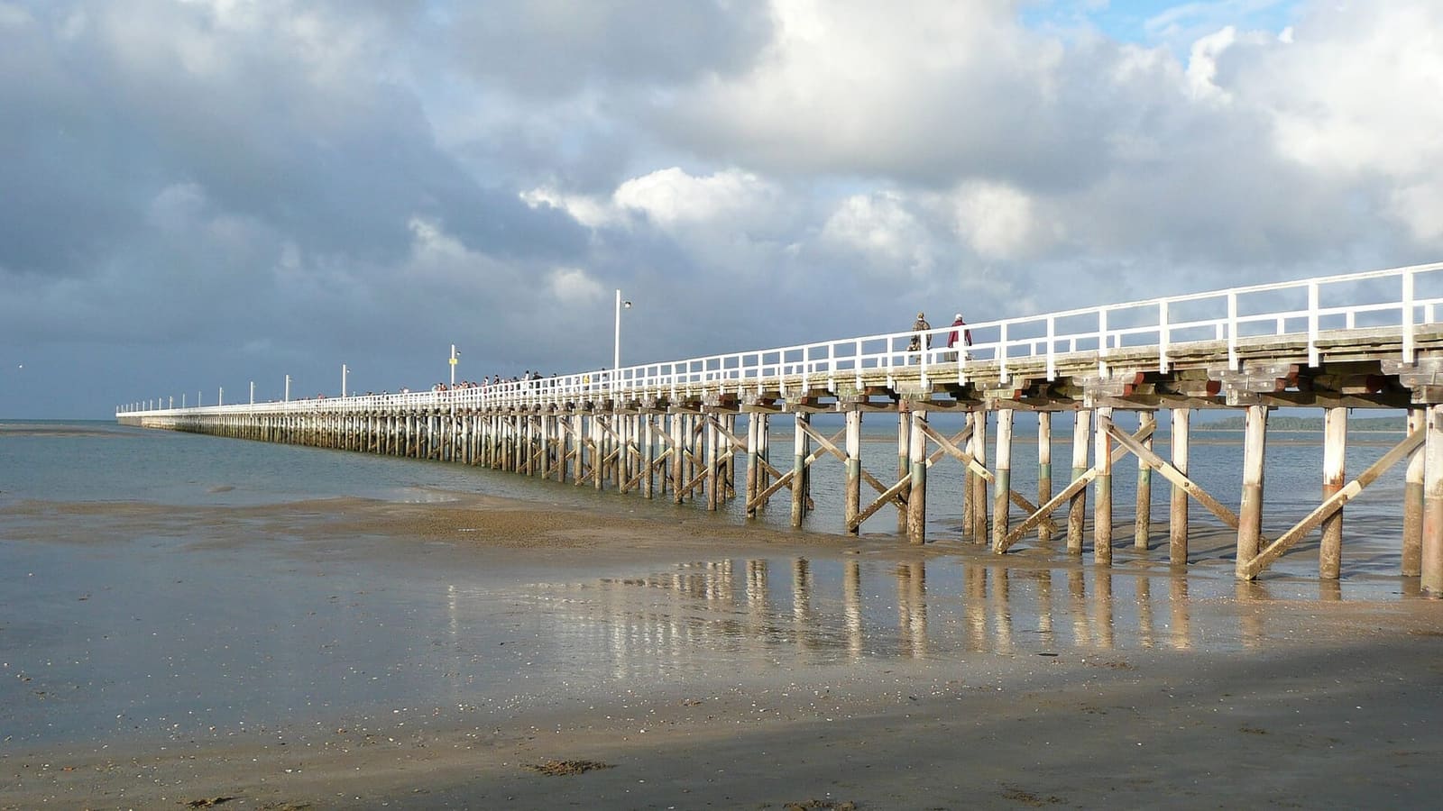 Urangan Pier stretching out to sea under a cloudy sky